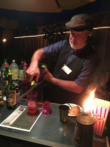Night of Mystery | POM 4/18: Lights! Camera! MURDER!!! Old Hollywood Style a man pouring a drink into a glass