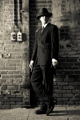 a man in a suit and hat