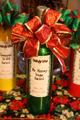 Night of Mystery | Ho Ho Homicide Extras! a bottle of wine next to a pile of wrapped presents