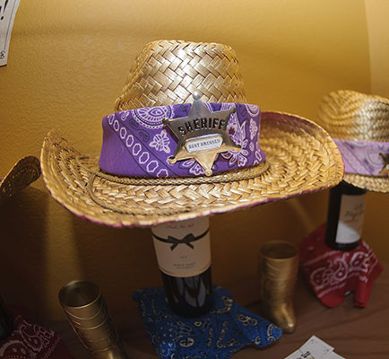 Night of Mystery | Saloon Party Decorations We purchased some inexpensive cowboy hats, spray painted them gold, added a bandana and a sheriff’s badge and woohla! You’ve got an award AND a fashion accessory!